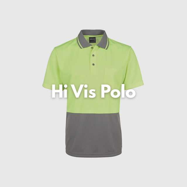 Construction worker wearing long sleeve hi-vis orange and black polo shirt on job site – custom safety workwear with free logo included.