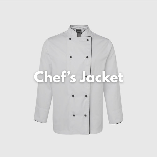 Smiling female chef wearing a crisp white chef jacket in a commercial kitchen – ideal for custom hospitality uniforms, restaurant staff apparel, and professional kitchen branding in Australia.