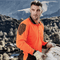 Construction worker wearing long sleeve hi-vis orange and black polo shirt on job site – custom safety workwear with free logo included.