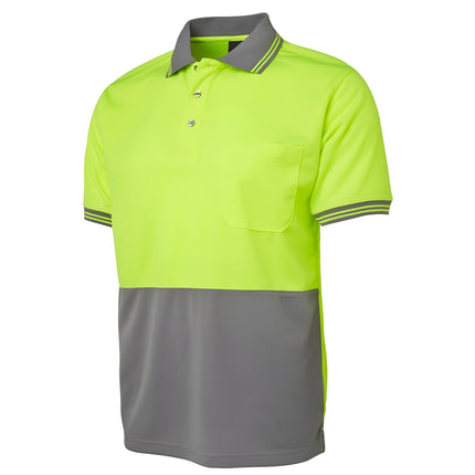 A close-up of a two-tone polo shirt. The top is neon yellow, and the bottom and collar are gray. It has thin stripes on the collar and sleeves.