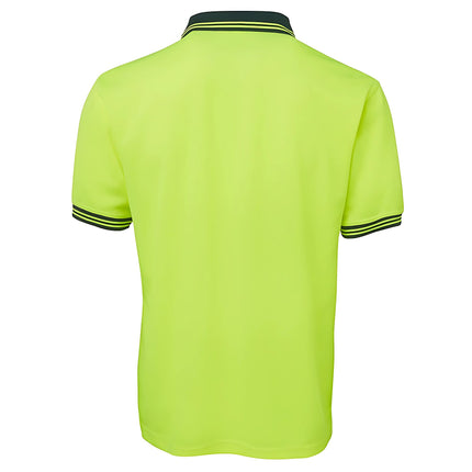A rear view of a two-tone polo shirt. The back is all neon yellow, and the collar and sleeve cuffs are dark green with two thin stripes.