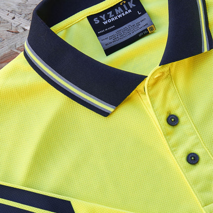 A close-up of a neon yellow polo shirt's collar and placket. The collar is dark blue with gray stripes.