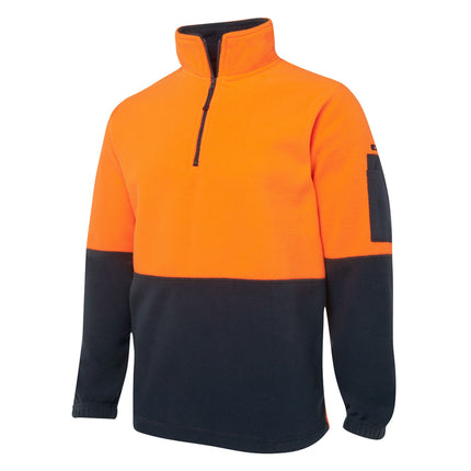 A close-up of a two-tone fleece pullover. The top is bright orange, and the bottom and sleeves are dark blue. It has a black half zipper on the high collar.