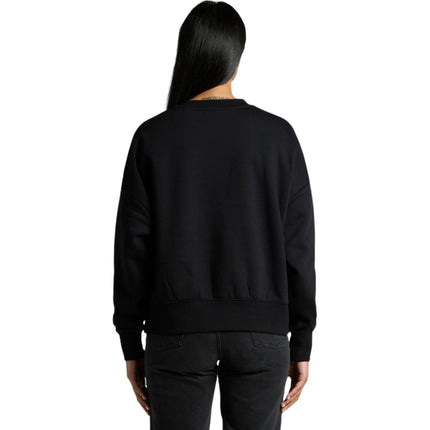 A model wearing a black AS Colour Women's Heavy Crew sweatshirt.