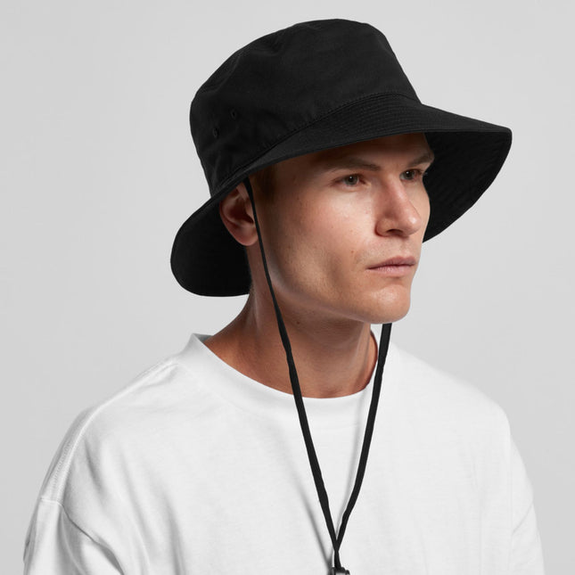 A person in a plain white shirt and a Personalised AS Colour Wide Brim Bucket Hat — No Minimum Order Custom Uniforms & Apparel Australia looks slightly right against a neutral background.