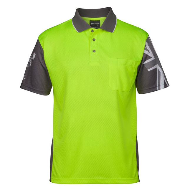 A front view of a neon yellow and dark gray short-sleeve polo shirt. It features a Union Jack print on the left sleeve, a Southern Cross star on the right, and a reinforced chest pocket. Made from a moisture-wicking fabric with UPF 50+ protection.