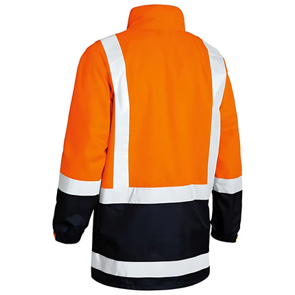 A rear view of an orange and dark blue work jacket. The jacket has a high collar and white reflective stripes on the back and arms.