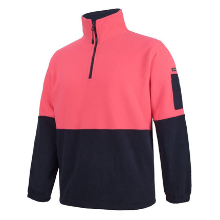 A close-up of a two-tone fleece pullover. The top is bright pink, and the bottom and sleeves are dark blue. It has a half zipper on the high collar and a small black pocket on the left sleeve.