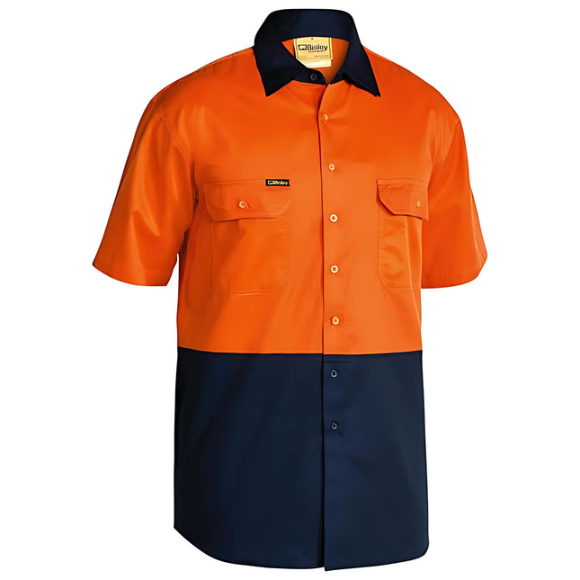 A short-sleeve work shirt in two colors. The top half is bright orange, and the bottom half is dark blue. It has a button-down front and two chest pockets with button flaps.