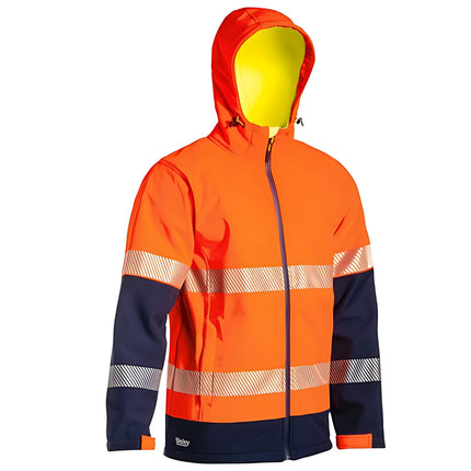 A close-up of a two-tone work jacket. The jacket is orange and dark blue with a hood and reflective stripes on the torso and arms.