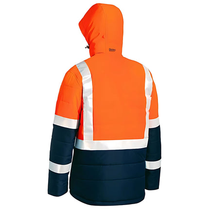 A rear view of an orange and dark blue work jacket. The jacket has a hood, and two white reflective stripes run vertically and horizontally across the back.