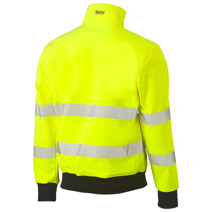 A rear view of a neon yellow and black work jacket. It has a high collar and two wide, gray reflective stripes across the back and arms.