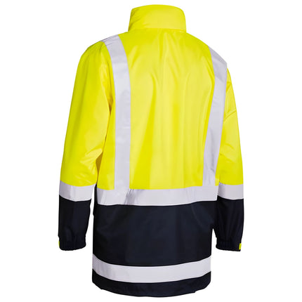 A rear view of a neon yellow and dark blue work jacket. It has a high collar and white reflective stripes on the back and arms.