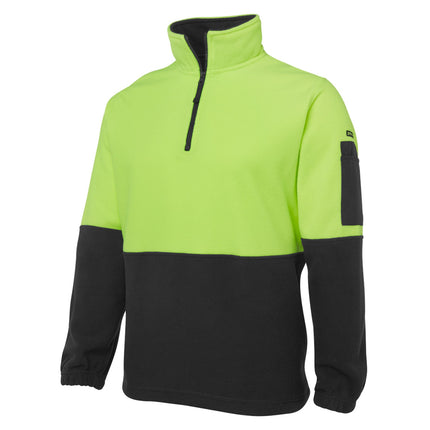 A close-up of a two-tone fleece pullover. The top is neon yellow, and the bottom and sleeves are black. It has a half zipper on the high collar and a black pocket on the left sleeve.
