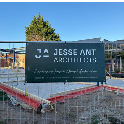 Jesse Ant Architects sign at a construction site with a clear blue sky.