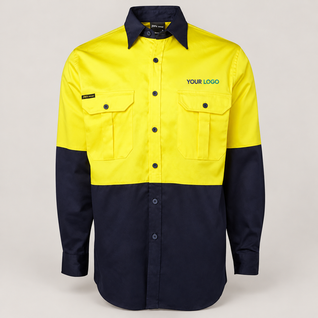 Illustrative front-view branding mock-up of JB's Wear 6HWL Yellow/Navy shirt with small navy-and-teal YOUR LOGO embroidery above the wearer-left chest pocket on a warm grey background.