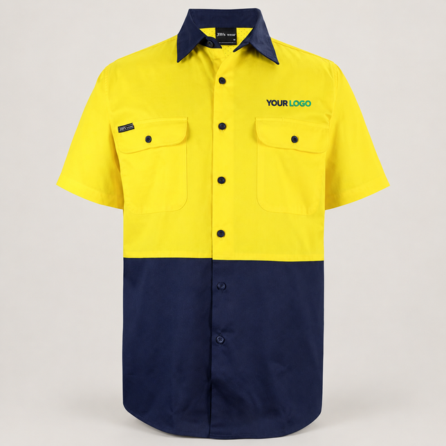 Illustrative front-view branding mock-up of JB's Wear 6HWSS Yellow/Navy shirt with small navy-and-teal YOUR LOGO embroidery above the wearer-left chest pocket on a warm grey background.