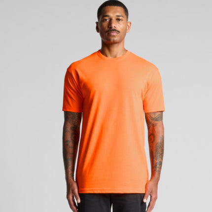 A man with tattoos on both arms models a bright orange short-sleeve t-shirt while facing the camera.