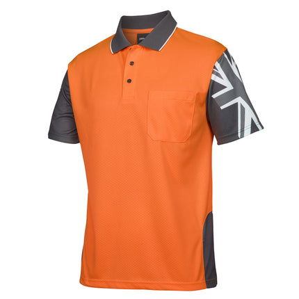 A close-up of an orange and dark gray short-sleeve polo shirt. It features a high collar with white piping and a reinforced chest pocket.