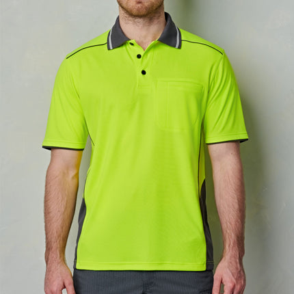 A man wears a neon yellow polo shirt with gray side panels, black piping, and a chest pocket.