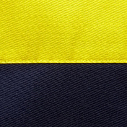 A close-up of a two-tone fabric. The top half is bright yellow and the bottom is dark blue, separated by a line of stitching.