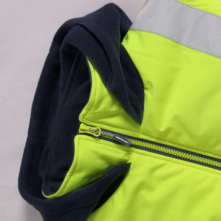 A close-up of the neon yellow vest zipper and dark blue fleece hood. The zipper is neon yellow with a black pull. The fleece lining and the hood are dark blue.