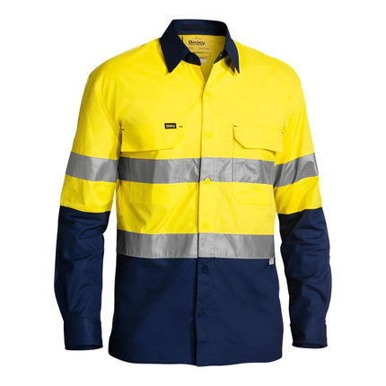 A front view of a long-sleeve, two-tone work shirt. The top is bright yellow with reflective stripes, and the bottom, sleeves, and collar are dark blue.