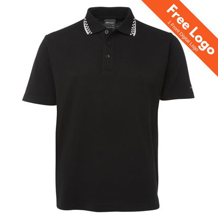 JB's Wear Chef Polo by JB's Wear: a black short-sleeve polo in double pique knit with a checkered black-and-white buttoned collar. Orange banner reads Free Logo | 1 Front Digital Logo—perfect hospitality uniform.