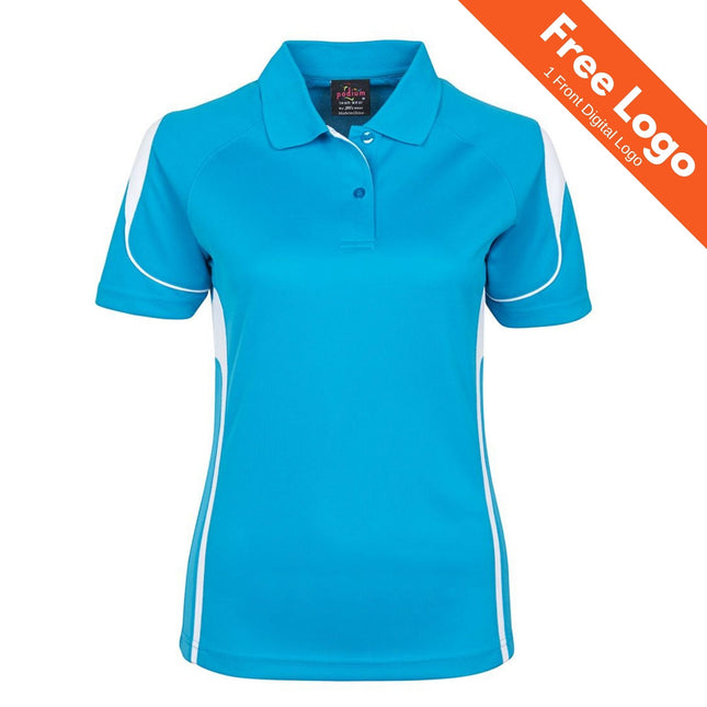 The JB's Wear Podium Ladies Bell Polo is a bright blue polo with white side panels and shoulder accents, made from moisture-wicking fabric. "Free Logo 1 Front Digital Logo" appears in an orange banner in the top right corner.