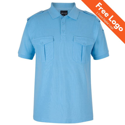 The JB’s Wear 250 Short Sleeve Epaulette Polo by JB’s Wear features light blue fabric, buttoned chest pockets, and shoulder epaulettes. An orange banner in the top right announces “Free Logo | 1 Front Digital Logo.”.