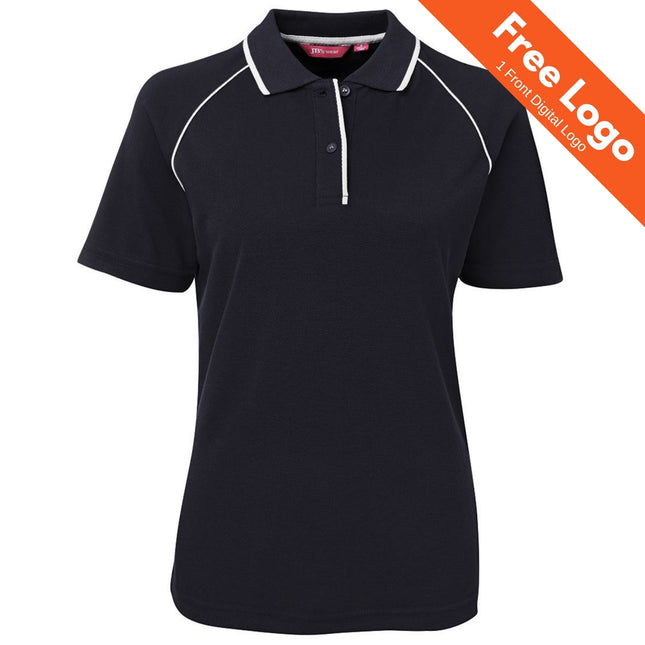The JB's Wear Ladies Raglan Polo is a black, short-sleeve polo with white piping on the collar and shoulders—perfect for work uniforms. An orange banner at the top right says, "Free Logo | 1 Front Digital Logo.