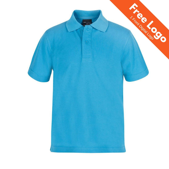 The JB's Wear Kids 210 Polo is a bright blue collared shirt with three buttons—ideal for school uniforms. An orange banner in the top right corner displays “Free Logo and 1 Front Digital Logo” in white text. Brand: JB's Wear.