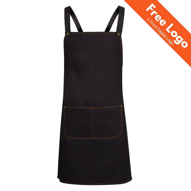The JB's Wear Cross Back Denim Apron with Strap by JB's Wear features black stonewash denim, brown stitching, two front pockets, and adjustable cross-back straps. An orange banner at the top right reads: Free Logo 1 Front Digital Logo.