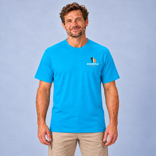 Model wearing a JB's 1HT Classic Tee in Aqua with an illustrative full-colour EXAMPLE CIVIL left-chest digital print, against a soft grey studio background.