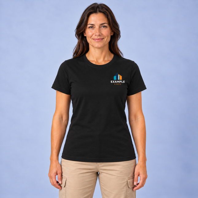 Model wearing a JB's 1LHT Ladies Tee black women's short sleeve cotton crew neck T-shirt with a small full-colour EXAMPLE CIVIL digital print on the left chest, against a soft grey studio background.