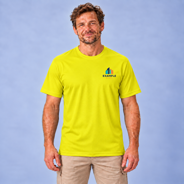 Model wearing a JB's 7PNFT Podium Poly Tee yellow short sleeve polyester pique crew neck T-shirt with a small full-colour EXAMPLE CIVIL digital print on the left chest, against a soft grey studio background.