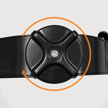 Close-up of a black ratchet harness adjustment dial on a hard hat, highlighted by an orange circular graphic indicating rotation.